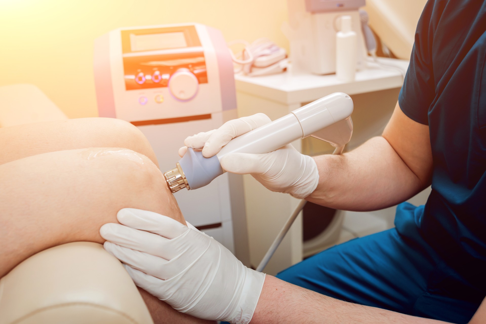 Shock wave therapy. The magnetic field, rehabilitation. Physiotherapist doctor performs surgery on a patient's knee